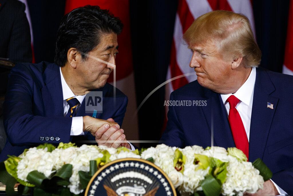 Evan Vucci FILE - In this Sept. 25, 2019, file photo, U.S. President Donald Trump, right, shakes hands with Japanese Prime Minister Shinzo Abe before signing an agreement on trade at the InterContinental Barclay New York hotel during the United Nations General Assembly, in New York. As Americans celebrate or fume over the new president-elect, many in Asia are waking up to the reality of a Joe Biden administration with decidedly mixed feelings. Relief and hopes of economic and environmental revival jostle with needling anxiety and fears of inattention. The resignation of Japanese Prime Minister Abe ended one of Trump’s few close, productive relationships with a foreign leader. (AP Photo/Evan Vucci, File)