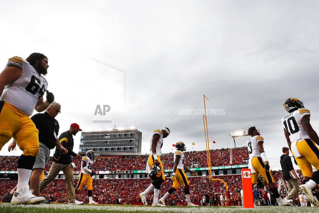Charlie Neibergall Iowa players walk off the field during a lightning delay in the first half of an NCAA college football game against Iowa State, Saturday, Sept. 14, 2019, in Ames, Iowa. (AP Photo/Charlie Neibergall)