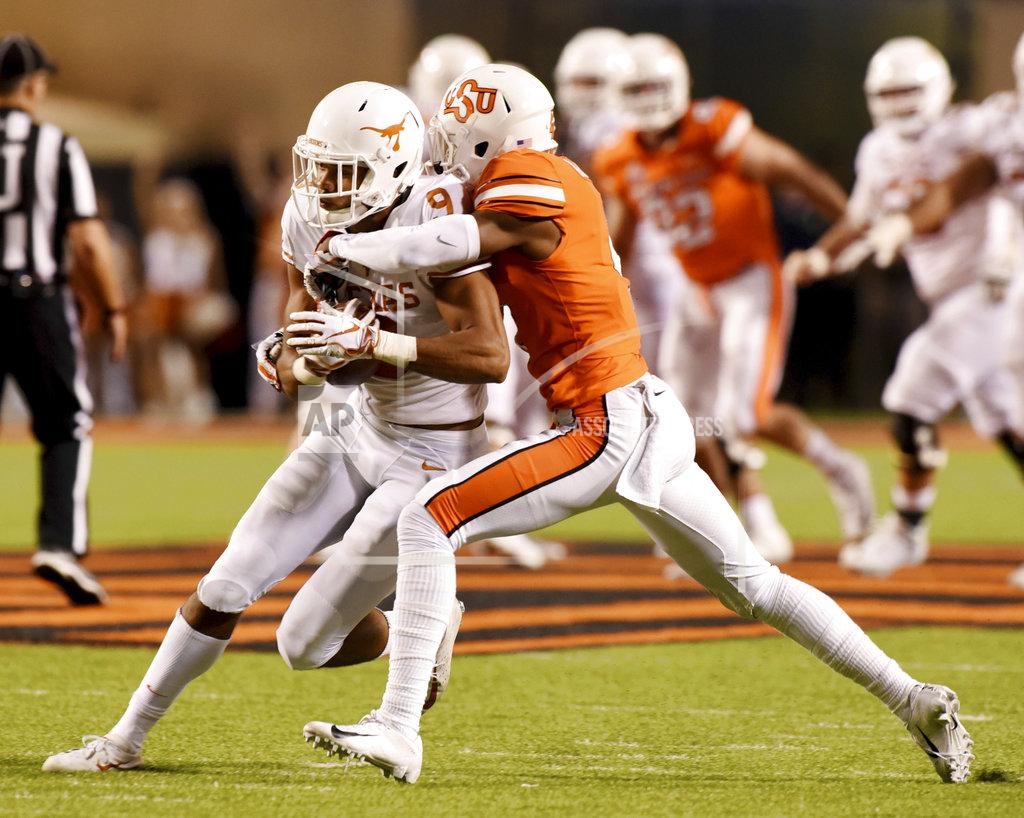 Brody Schmidt Oklahoma State cornerback A.J. Green, right, tackles Texas wide receiver Collin Johnson in the second half of an NCAA college football game in Stillwater, Okla., Saturday, Oct. 27, 2018. (AP Photo/Brody Schmidt)