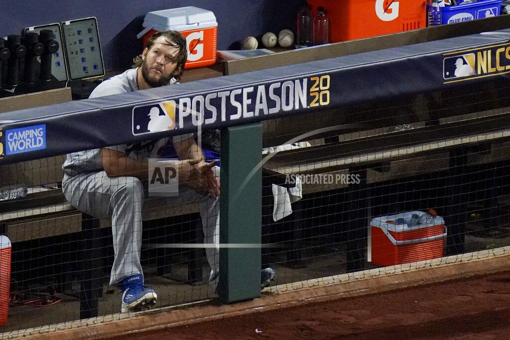 Sue Ogrocki Los Angeles Dodgers starting pitcher Clayton Kershaw sits in the dugout after leaving the game during the sixth inning in Game 4 of a baseball National League Championship Series against the Atlanta Braves Thursday, Oct. 15, 2020, in Arlington, Texas. (AP Photo/Sue Ogrocki)