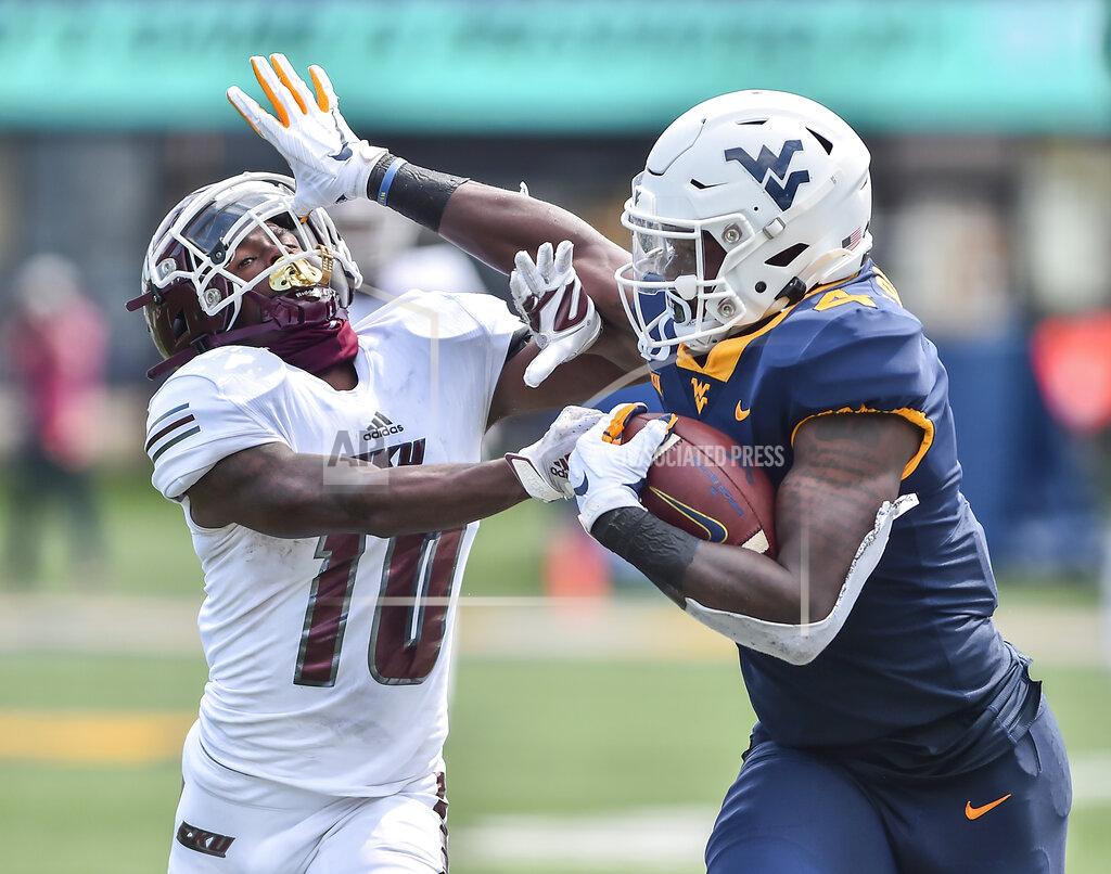 William Wotring West Virginia running back Leddie Brown (4) stiff arms Eastern Kentucky's Davion Ross (10) during an NCAA college football game on Saturday, Sept. 12, 2020, in Morgantown, W.Va. (William Wotring/The Dominion-Post via AP)