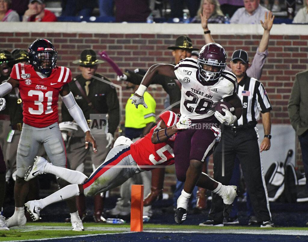 Thomas Graning Texas A&M running back Isaiah Spiller (28) carries the ball past Mississippi defensive back Jon Haynes (5) for a 22-yard touchdown during the second half of an NCAA college football game in Oxford, Miss., Saturday, Oct. 19, 2019. Texas A&M won 24-17. (AP Photo/Thomas Graning)