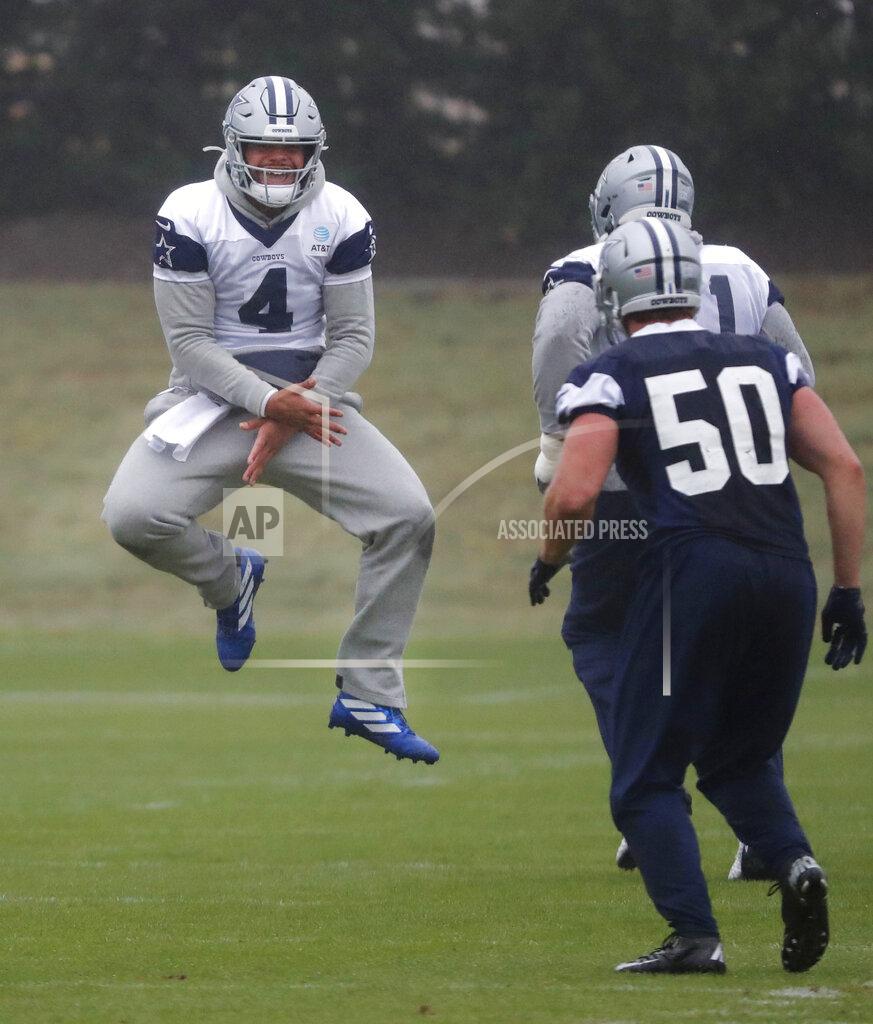Dallas Cowboys quarterback Dak Prescott (4) jumps to get fired up with teammates, offensive tackle La'el Collins and linebacker Sean Lee (50) during an NFL football team practice in Frisco, Texas, Tuesday, Oct. 29, 2019. The Cowboys will play the New York Giants Monday. (AP Photo/LM Otero)