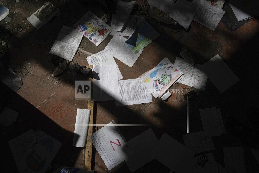 Evgeniy Maloletka Children's drawings for Russian soldiers lie on the floor in the school which was used as a Russian military hospital in the recently retaken area of Izium, Ukraine, Wednesday, Sept. 21, 2022. (AP Photo/Evgeniy Maloletka)