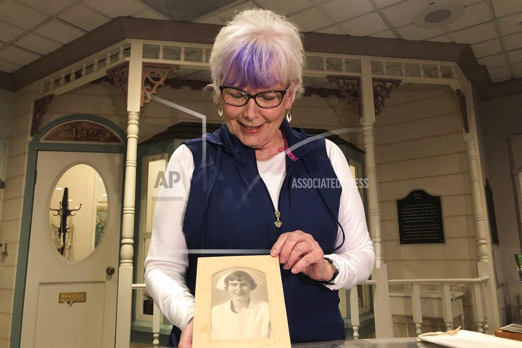 Haven Daley Nurse practitioner Sigrid Stokes, 76, holds a photograph of her mother at the Salinas Valley Memorial Hospital in Salinas, Calif., Wednesday, Feb. 3, 2021. Stokes is following in her family's footsteps during the pandemic. In 1918, Stokes' mother Kristine Berg Mueller was a 14-year-old hospital volunteer in Norway during the Spanish Flu pandemic, putting her in regular contact with the deadly disease. (AP Photo/Haven Daley)