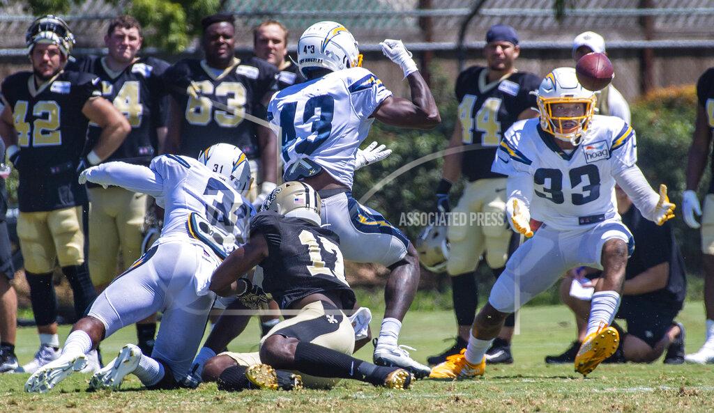 Los Angeles Chargers safety Derwin James Jr., right, catches a tipped pass during the NFL football team's joint practice with the New Orleans Saints on Thursday, Aug. 15, 2019, in Costa Mesa, Calif. (Mark Rightmire/The Orange County Register via AP)