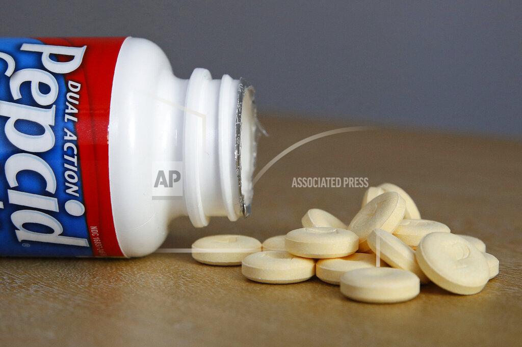 Patrick Semansky This June 15, 2020 photo shows a bottle and tablets of Pepcid antacid in Washington. The U.S. government's Pepcid project has revealed what critics describe as the Trump administration’s disregard for science and anti-corruption rules meant to guard against taxpayer dollars going to political cronies or funding projects that aren’t rigorously designed. (AP Photo/Patrick Semansky)