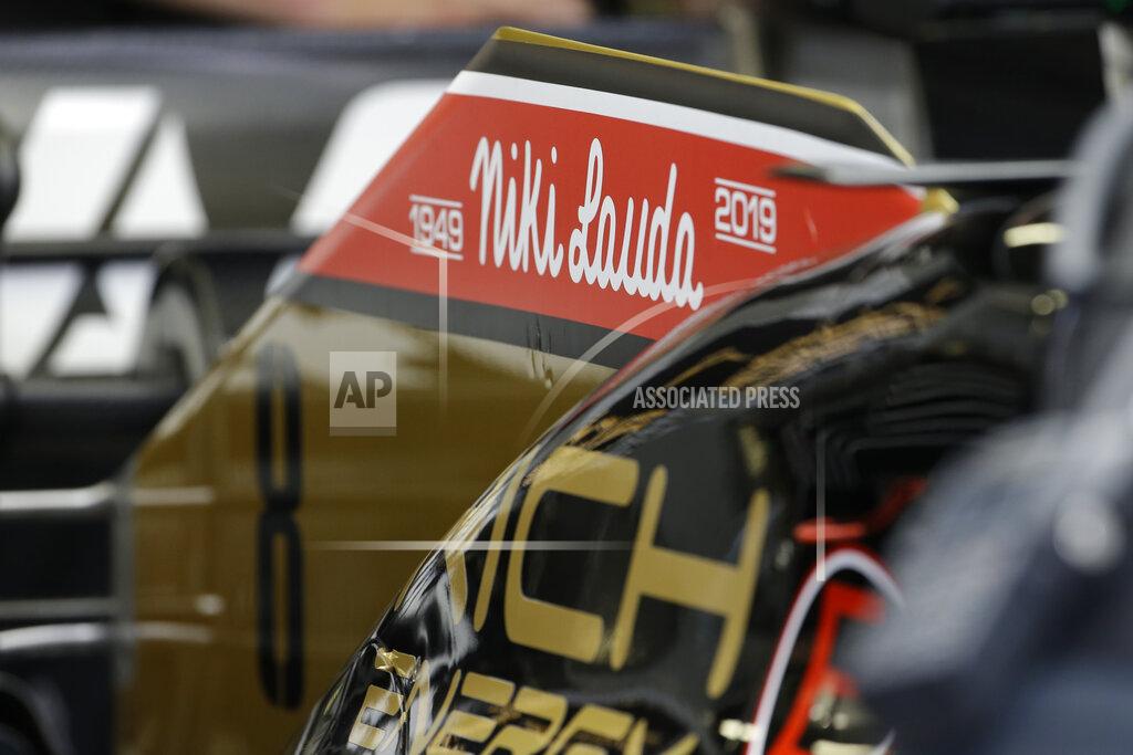 Luca Bruno The name of three-time Formula One world champion Niki Lauda is written on Romain Grosjean's Haas race car, top, during the second practice session at the Monaco racetrack, in Monaco, Thursday, May 23, 2019. Three-time Formula One world champion Niki Lauda, who won two of his titles after a horrific crash that left him with serious burns and went on to become a prominent figure in the aviation industry, has died on May 21, 2109. He was 70. (AP Photo/Luca Bruno)
