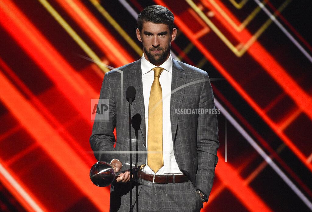 Chris Pizzello FILE - Michael Phelps accepts the award for best record-breaking performance at the ESPYS on July 12, 2017, in Los Angeles. Olympians including Phelps, Apolo Ohno and Jeremy Bloom are opening up about their mental health struggles in a new sobering documentary about suicide and depression among the world's greatest athletes. Many of the athletes are sharing their pain for the first time in HBO's "The Weight of Gold," which aims to expose the problem, incite change among Olympics leadership and help others experiencing similar issues feel less alone. (Photo by Chris Pizzello/Invision/AP, File)