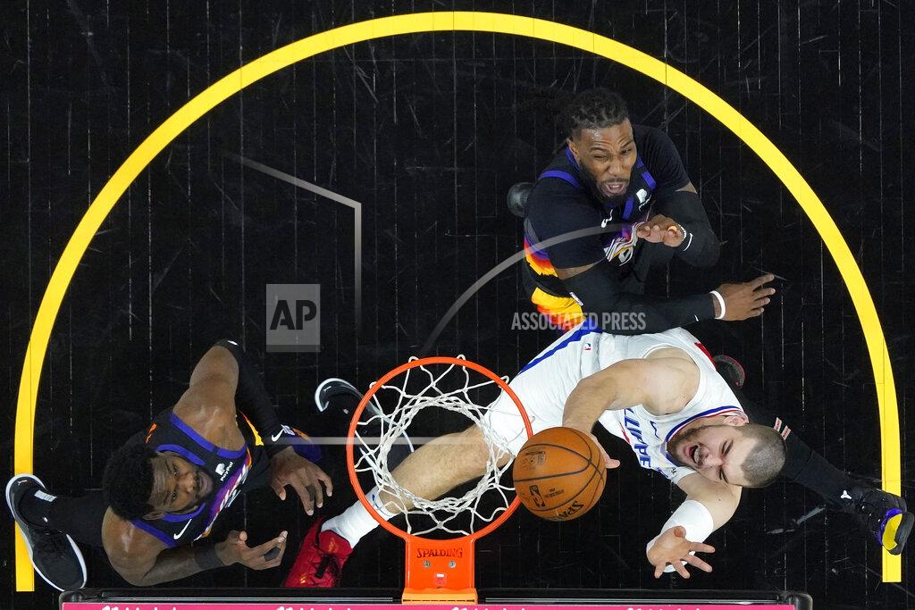 Matt York Los Angeles Clippers center Ivica Zubac, right, shoots as Phoenix Suns forward Jae Crowder and center Deandre Ayton, left, defend during the first half of game 2 of the NBA basketball Western Conference Finals, Tuesday, June 22, 2021, in Phoenix. (AP Photo/Matt York)
