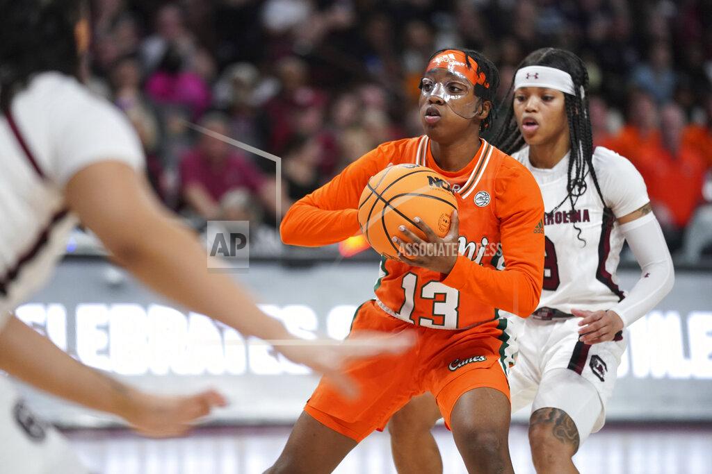 Sean Rayford Miami guard Lashae Dwyer (13) looks to pass the ball against South Carolina guard Destanni Henderson, right, during the first half of a second-round game in the NCAA college basketball tournament, Sunday, March 20, 2022, in Columbia, S.C. South Carolina won 49-33. (AP Photo/Sean Rayford)
