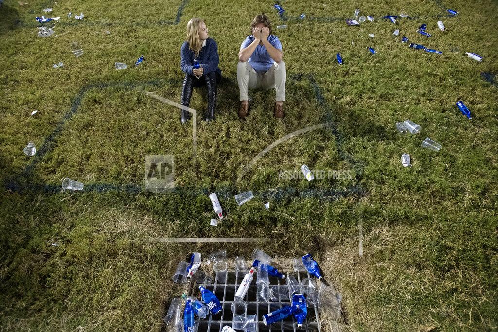 Jeffrey Mcwhorter SMU sophomores Ashlyn Heintzelman and Peter Warner sit in a box marked on the grass to facilitate social distancing during the second half of an NCAA college football game between SMU and Cincinnati Saturday, Oct. 24, 2020, in Dallas. Cincinnati won 42-13. (AP Photo/Jeffrey McWhorter)