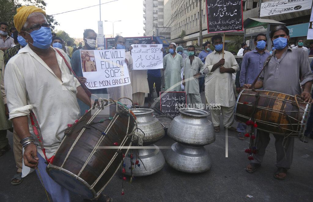 Owners of marriage and banquet halls protest against the government demanding the opening of their halls which were closed by authorities to help to contain the spread of coronavirus, Tuesday, June 23, 2020 in Karachi, Pakistan. (AP Photo/Fareed Khan)