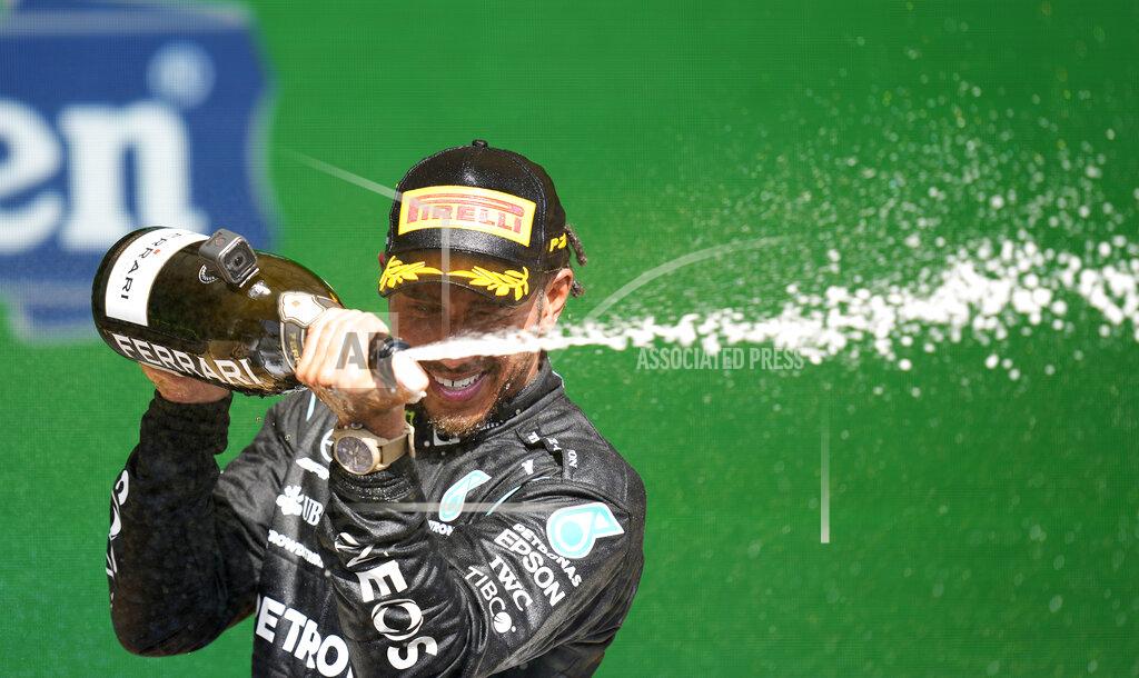 Andre Penner Mercedes driver Lewis Hamilton, of Britain, sprays champagne at the podium after winning the Brazilian Formula One Grand Prix at the Interlagos race track in Sao Paulo, Brazil, Sunday, Nov. 14, 2021. (AP Photo/Andre Penner)