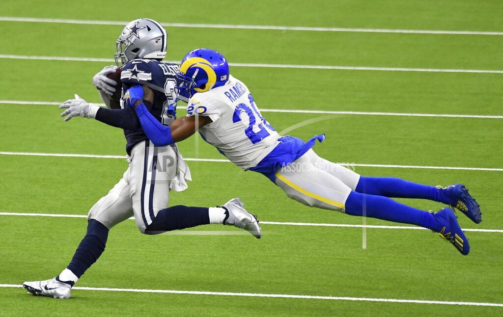 Running back Ezekiel Elliott (21) of the Dallas Cowboys runs for a first down against cornerback Jalen Ramsey (20) of the Los Angeles Rams in the first half of a NFL football game on opening night at SoFi Stadium in Inglewood on Sunday, September 13, 2020. (Keith Birmingham/The Orange County Register via AP)