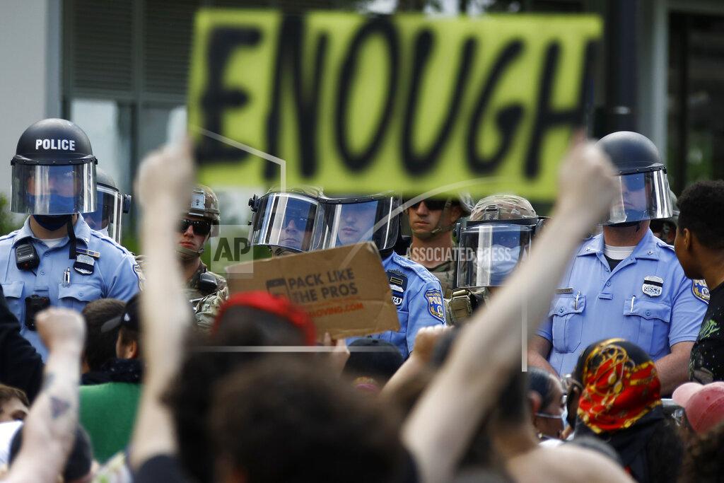 Matt Slocum FILE - In this June 1, 2020, file photo, protesters rally as Philadelphia Police officers and Pennsylvania National Guard soldiers look on in Philadelphia, over the death of George Floyd, a black man who was in police custody in Minneapolis. (AP Photo/Matt Slocum, File)
