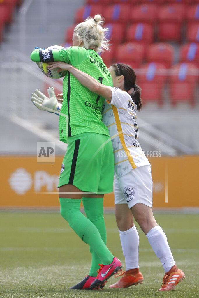 Rick Bowmer Utah Royals FC midfielder Diana Matheson, right, tries to take the ball from Houston Dash goalkeeper Jane Campbell (1) during the second half of an NWSL Challenge Cup soccer match at Zions Bank Stadium Tuesday, June 30, 2020, in Herriman, Utah. Matheson received a yellow card. (AP Photo/Rick Bowmer)