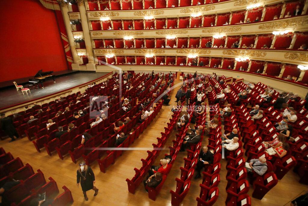 Antonio Calanni FILE - Spectators sit apart from each other to respect social distancing, prior to a show at the La Scala theater in Milan Italy, on July 6, 2020. La Scala opera house reopened after a four-month shutdown due to the COVID-19 restriction measures. (AP Photo/Antonio Calanni, File)