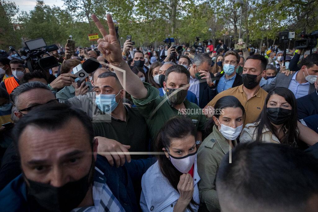 Manu Fernandez Vox party leader Santiago Abascal waves after a party rally in Madrid's Vallecas neigborhood, a traditional left-wing bastion, Spain, Wednesday, April 7, 2021. Scuffles started when the national leader of Vox, Santiago Abascal, approached a crowd which had gathered to protest the party rally. Riot peace charged the bunches of protesters to keep them away from Abascal and other members of his party campaigning for upcoming regional elections in the area including Spain's capital. (AP Photo/Manu Fernandez)