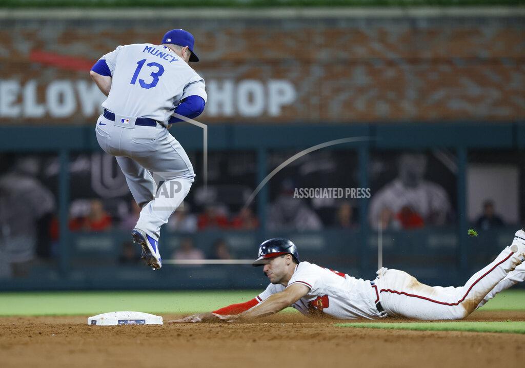 Bob Andres Atlanta Braves' Matt Olson is safe at second, sliding in under Los Angeles Dodgers' Max Muncy during the tenth inning of a baseball game won by the Los Angeles Dodgers 5-3 on Sunday, June 26, 2022, in Atlanta. (AP Photo/Bob Andres)