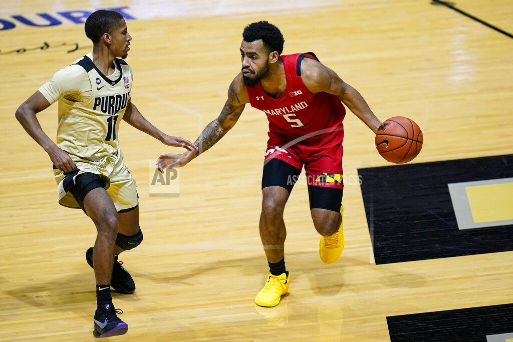 Michael Conroy Maryland guard Eric Ayala (5) drives on Purdue guard Isaiah Thompson (11) during the first half of an NCAA college basketball game in West Lafayette, Ind., Friday, Dec. 25, 2020. (AP Photo/Michael Conroy)