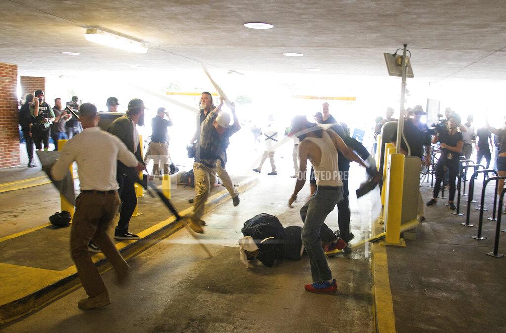 Zach D. Roberts FILE - DeAndre Harris, bottom is assaulted in a parking garage beside the Charlottesville police station after a white nationalist rally was dispersed by police, on Aug. 12, 2017 in Charlottesville, Va. Harris, an African-American man who was severely beaten the day of a violent white nationalist rally, and then charged with misdemeanor assault in the same incident. The NAACP, the nation's oldest civil rights organization said it will propose a sweeping plan meant to protect Black Americans from white supremacist violence, in response to a hate-fueled massacre that killed 10 Black people in Buffalo, New York last weekend. (Zach D. Roberts via AP, File)