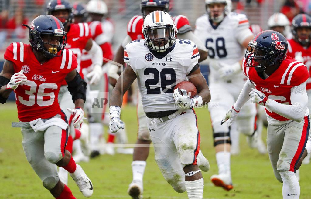Rogelio V. Solis Auburn running back JaTarvious Whitlow (28) runs past Mississippi defenders towards the goal line, before fumbling the ball into the end zone, during the second half of an NCAA college football game on Saturday, Oct. 20, 2018, in Oxford, Miss. Auburn recovered the fumble for a touchdown and won 31-16. (AP Photo/Rogelio V. Solis)
