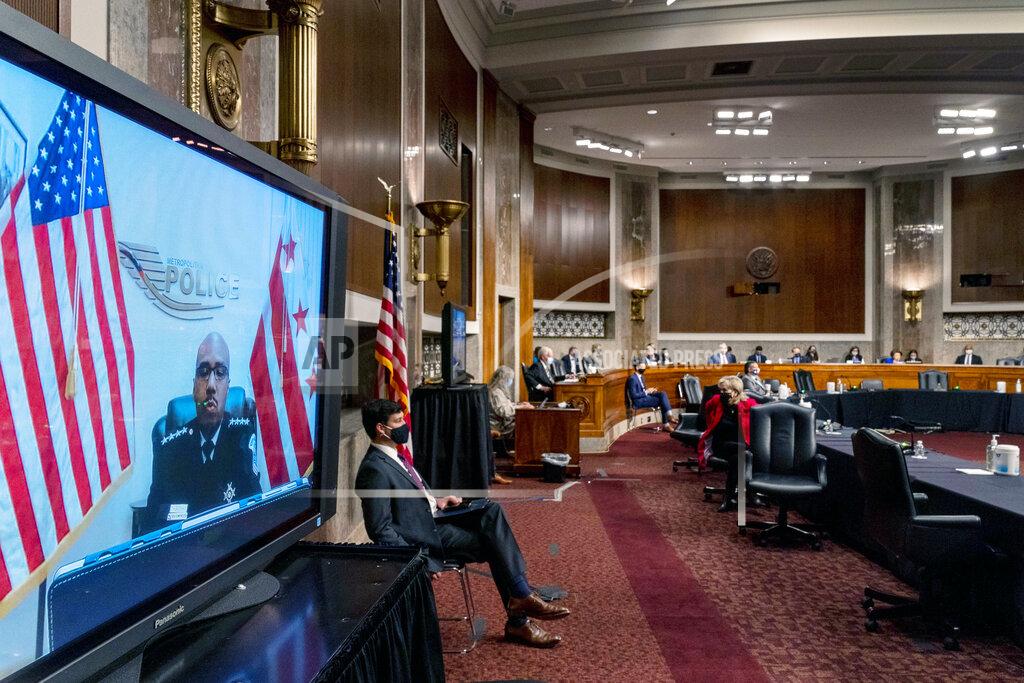Andrew Harnik Washington Metropolitan Police Department Acting Chief of Police Robert Contee III, left, testifies via teleconference before a Senate Homeland Security and Governmental Affairs & Senate Rules and Administration joint hearing on Capitol Hill, Washington, Tuesday, Feb. 23, 2021, to examine the January 6th attack on the Capitol. (AP Photo/Andrew Harnik, Pool)