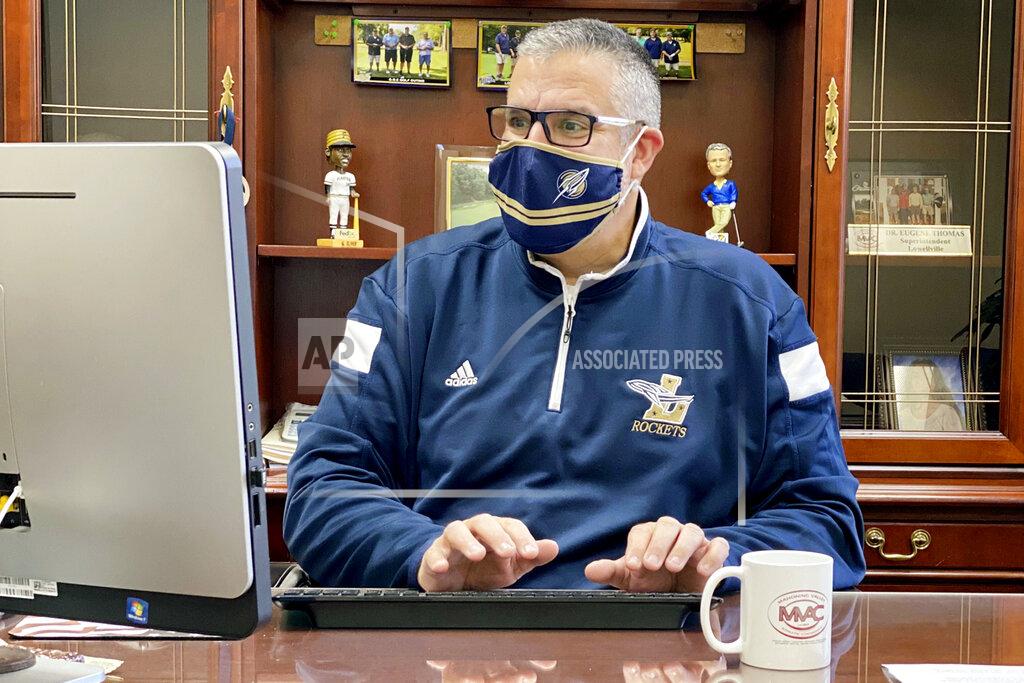 Uncredited In this November 2020 photo, provided by Eugene "Geno" Thomas, Thomas, superintendent of the Lowellville, Ohio, School District, works in his office. Contact tracing and isolation protocols meant to contain the spread of the coronavirus are sidelining school employees and frustrating efforts to continue in-person learning. “It boils down to the staff,” Thomas said. “If you can’t staff a school, you have to bring it to remote.” (Courtesy of Eugene Thomas via AP)