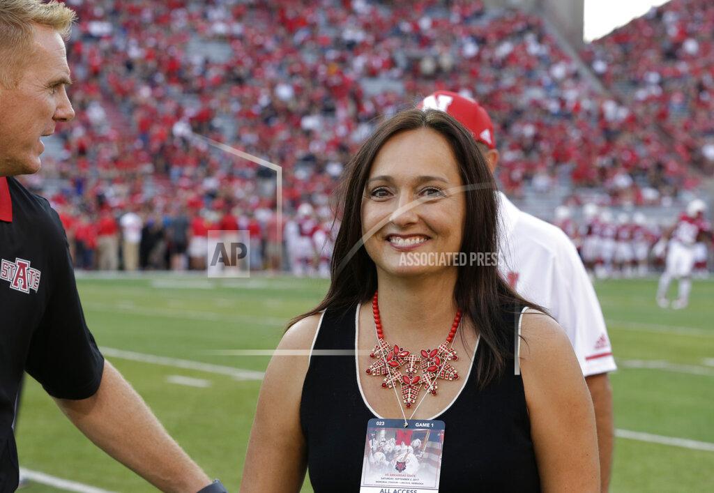 Nati Harnik FILE - In this Sept. 2, 2017, file photo, Wendy Anderson, center, wife of Arkansas State head coach Blake Anderson, obscured at left, smiles after chatting with Nebraska head coach Mike Riley, rear, before an NCAA college football game in Lincoln, Neb. Wendy Anderson has died after a two-year fight with breast cancer.
Blake Anderson says his wife died Monday night, Aug. 19, 2019, just hours after the school announced he would be taking a leave of absence. He said on Twitter : "She passed as peacefully & gracefully as you could ever hope." (AP Photo/Nati Harnik, File)