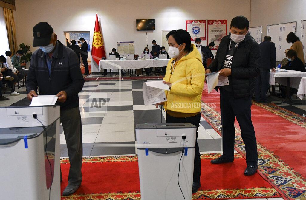Vladimir Voronin Voters cast their ballots at a polling station during the referendum in Bishkek, Kyrgyzstan, Sunday, April 11, 2021. Voters in Kyrgyzstan cast ballots Sunday on whether to approve a new constitution that would substantially increase the president's powers. The Sunday referendum comes three months after Sadyr Zhaparov was elected president, following the ouster of the previous president amid protests, the third time in 15 years that a leader of the Central Asian country had been driven from office in a popular uprising. (AP Photo/Vladimir Voronin)