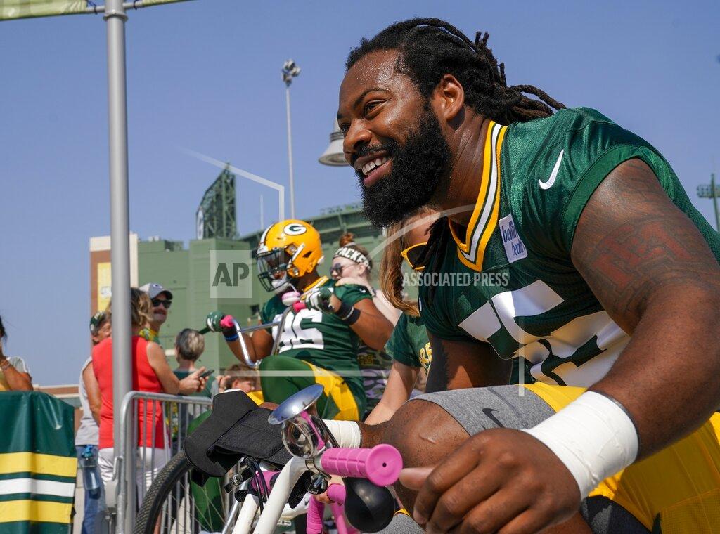 Morry Gash Green Bay Packers' Za'Darius Smith (55) and Kingsley Keke ride bikes to NFL football training camp Thursday, July 25, 2019, in Green Bay, Wis. (AP Photo/Morry Gash)
