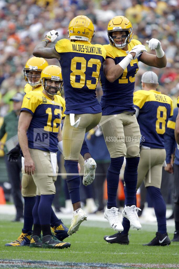 Mike Roemer FILE - In this Sept. 22, 2019, file photo, Green Bay Packers wide receiver Marquez Valdes-Scantling (83) celebrates with Allen Lazard (13) after catching a touchdown pass as quarterback Aaron Rodgers (12) watches during the first half of an NFL football game against the Denver Broncos in Green Bay, Wis. Green Bay needs younger wideouts such as Valdes-Scantling and Lazard to step up and help out three-time Pro Bowl selection Davante Adams after the Packers lost the only major offseason addition to their receiving corps when Devin Funchess opted against playing this year. (AP Photo/Mike Roemer, File)