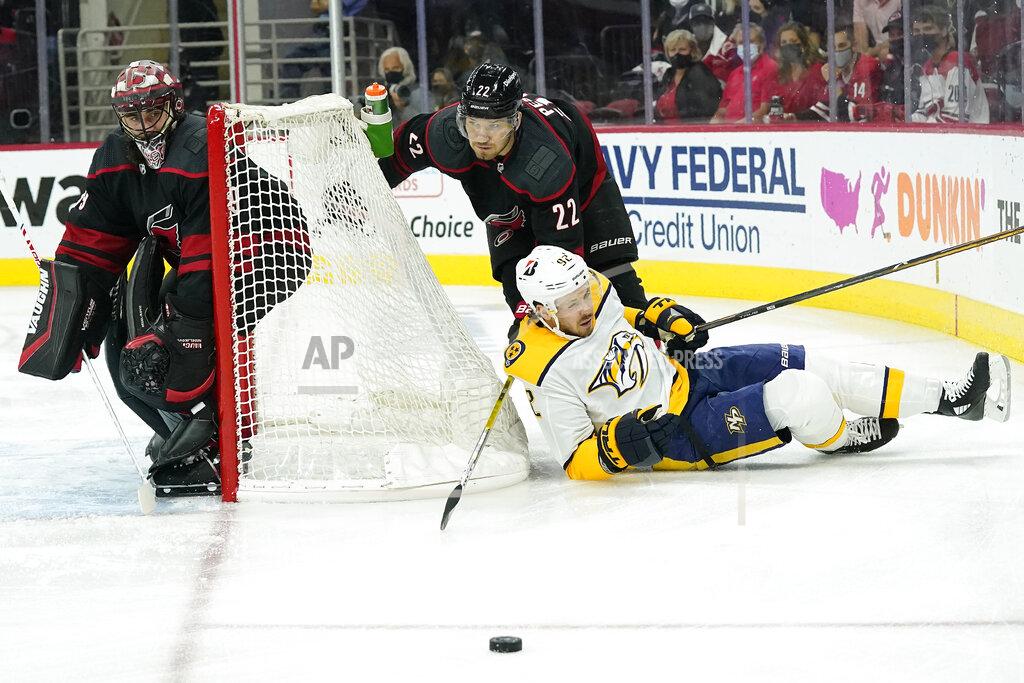 Gerry Broome Carolina Hurricanes goaltender Alex Nedeljkovic, left, and defenseman Brett Pesce (22) defend the goal while Nashville Predators center Ryan Johansen (92) falls to the ice during the first period in Game 5 of an NHL hockey Stanley Cup first-round playoff series in Raleigh, N.C., Tuesday, May 25, 2021. (AP Photo/Gerry Broome)