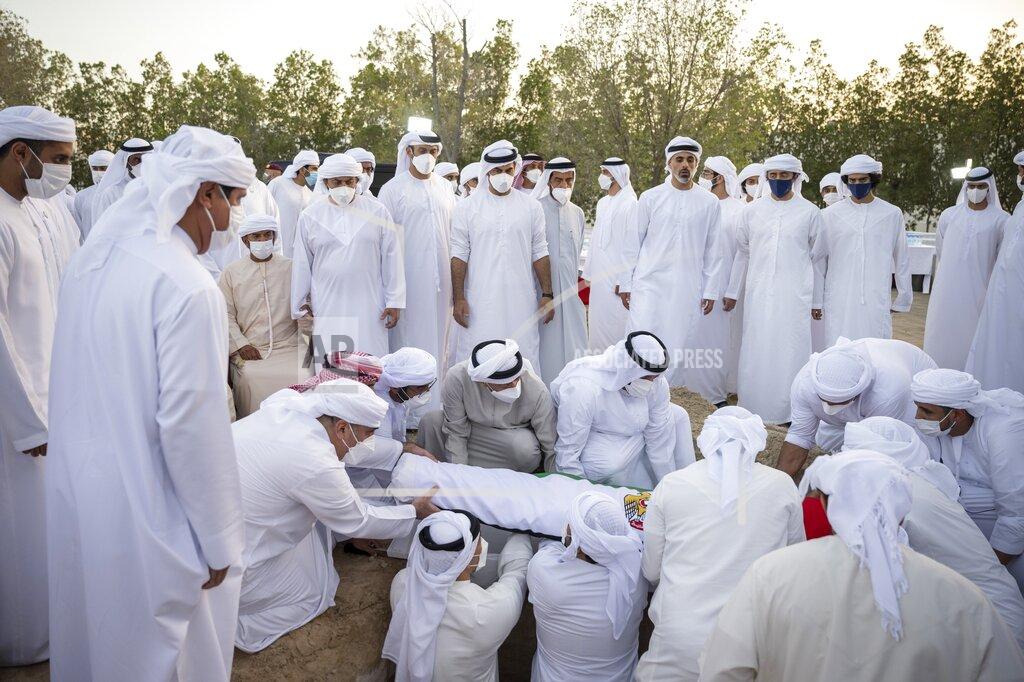 Abdulla Al Junaibi This photo made available by the Ministry of Presidential Affairs, shows Sheikh Mohamed bin Zayed Al Nahyan, Ruler of Abu Dhabi, center left, with others, attends the burial of Sheikh Khalifa bin Zayed Al Nahyan, President of the United Arab Emirates, with other members of royal family at Al Bateen cemetery, in Abu Dhabi, Friday, May 13, 2022. (Ministry of Presidential Affairs via AP/Abdulla Al Junaibi)