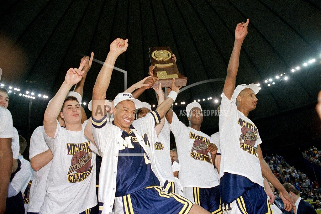Bob Jordan FILE - In this April 4, 1989, file photo, Michigan basketball players celebrate with the national championship trophy after defeating Seton Hall 80-79 in the NCAA college basketball Final Four final game in Seattle. (AP Photo/Bob Jordan, File)