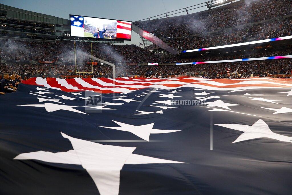 Charles Rex Arbogast A flag covers the field before an NFL football game between the Green Bay Packers and the Chicago Bears Thursday, Sept. 5, 2019, in Chicago. (AP Photo/Charles Rex Arbogast)