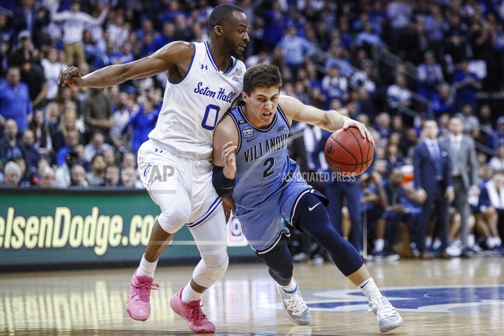 John Minchillo Villanova's Collin Gillespie (2) drives against Seton Hall's Quincy McKnight (0) during the first half of an NCAA college basketball game, Wednesday, March 4, 2020, in Newark, N.J. (AP Photo/John Minchillo)