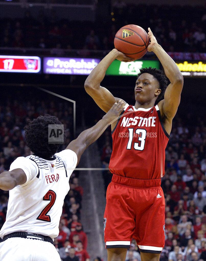 Timothy D. Easley North Carolina State guard C.J. Bryce (13) shoots over Louisville guard Darius Perry (2) during the first half of an NCAA college basketball game in Louisville, Ky., Thursday, Jan. 24, 2019. (AP Photo/Timothy D. Easley)