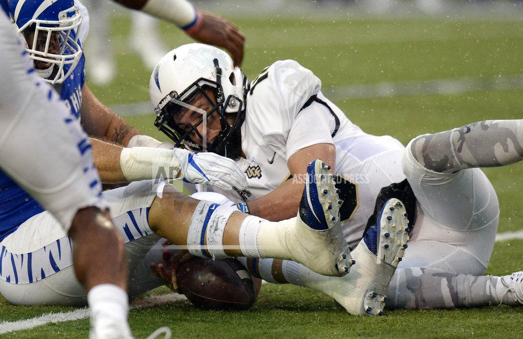 Mark Zaleski Central Florida quarterback McKenzie Milton, right, recovers his own fumble against Memphis during the second half of an NCAA college football game Saturday, Oct. 13, 2018, in Memphis, Tenn. Central Florida won 31-30. (AP Photo/Mark Zaleski)