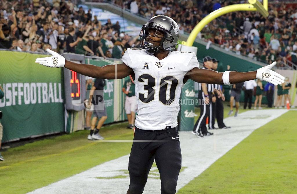 Mike Carlson Central Florida's Greg McCrae celebrates after his third rushing touchdown against South Florida during the second half of an NCAA college football game Friday, Nov. 23, 2018, in Tampa, Fla. (AP Photo/Mike Carlson)