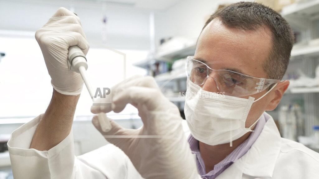 In this image from video provided by Washington University, researcher Nicolas Barthelemy works on a p-tau217 test for Alzheimer's disease at a laboratory in St. Louis, Mo., on Monday, July 27, 2020. Several companies and universities have developed versions of these tests, which look for a form of tau protein, one of the substances that can build up and damage the brains of people with Alzheimer’s. (Huy Mach/University of Washington via AP)