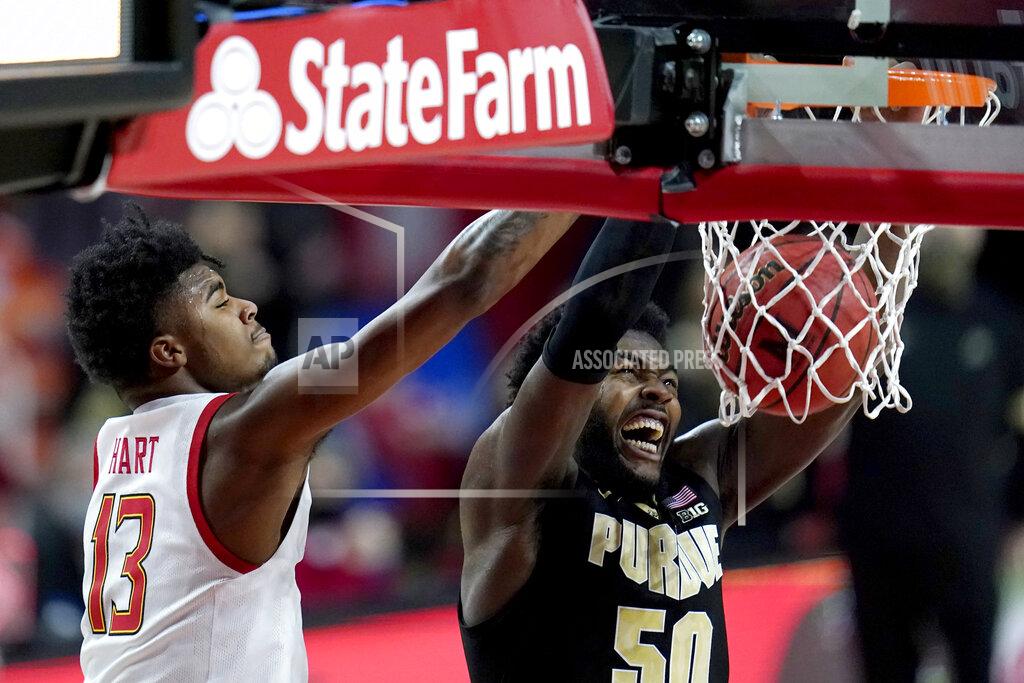 Julio Cortez Purdue forward Trevion Williams (50) dunks on Maryland guard Hakim Hart (13) during the first half of an NCAA college basketball game, Tuesday, Feb. 2, 2021, in College Park. (AP Photo/Julio Cortez)