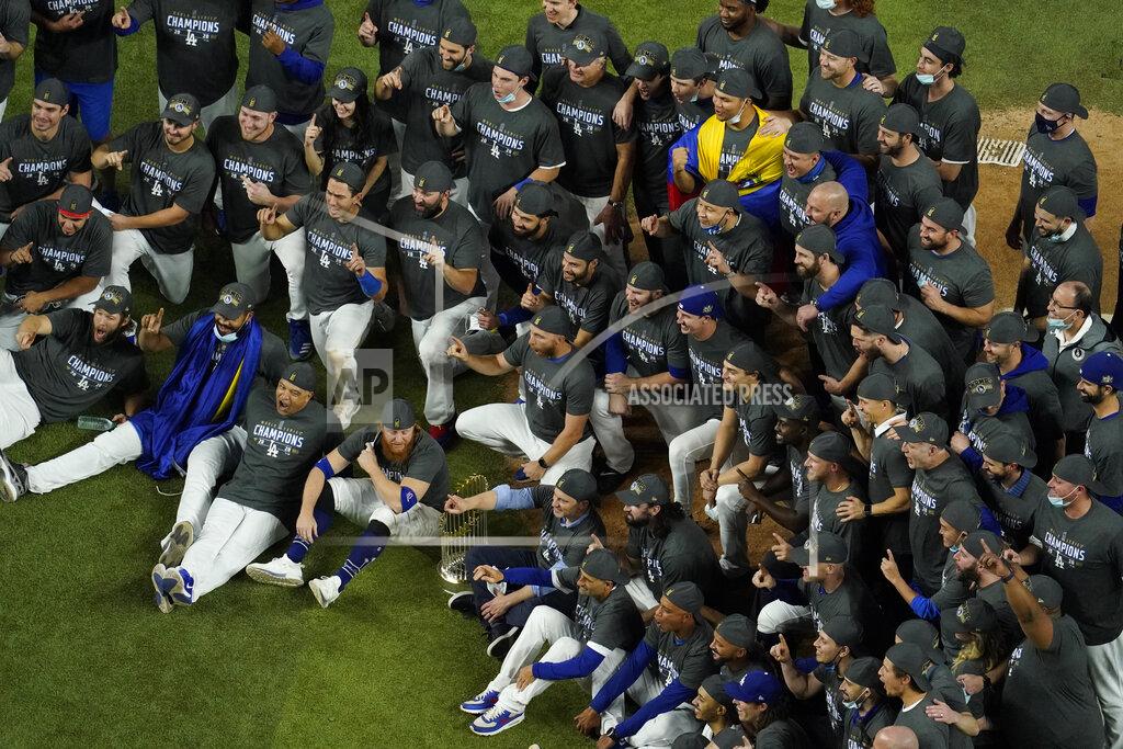 David J. Phillip Los Angeles Dodgers manager Dave Robert and third baseman Justin Turner pose for a group picture after defeating the Tampa Bay Rays 3-1 to win the baseball World Series in Game 6 Tuesday, Oct. 27, 2020, in Arlington, Texas. (AP Photo/David J. Phillip)