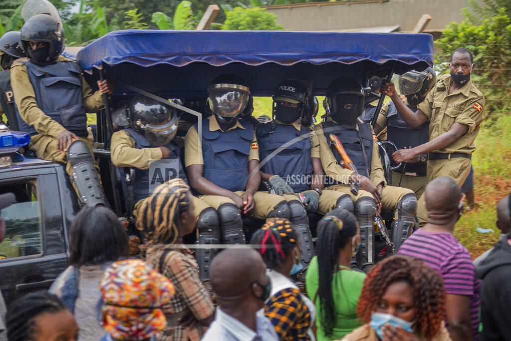 Jerome Delay Security forces drive past a polling station in Kampala, Uganda, Thursday, Jan. 14, 2021. Ugandans are voting in a presidential election tainted by widespread violence that some fear could escalate as security forces try to stop supporters of leading opposition challenger BobiWine from monitoring polling stations.(AP Photo/Jerome Delay)