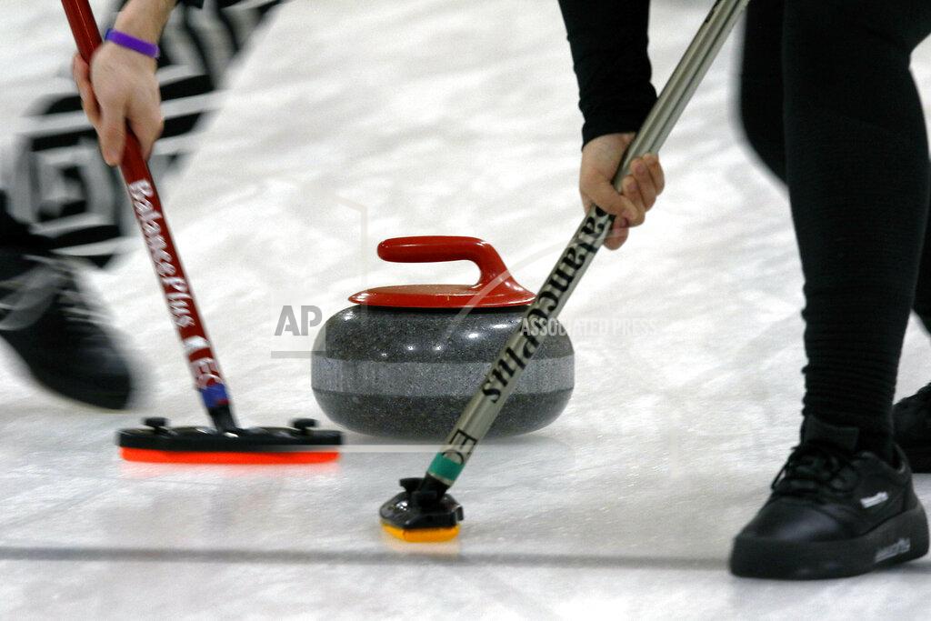 Bill Sikes Members of the Colgate curling club sweep ahead of the rock during the college curling national championship, Friday, March 8, 2019, in Wayland, Mass. (AP Photo/Bill Sikes)