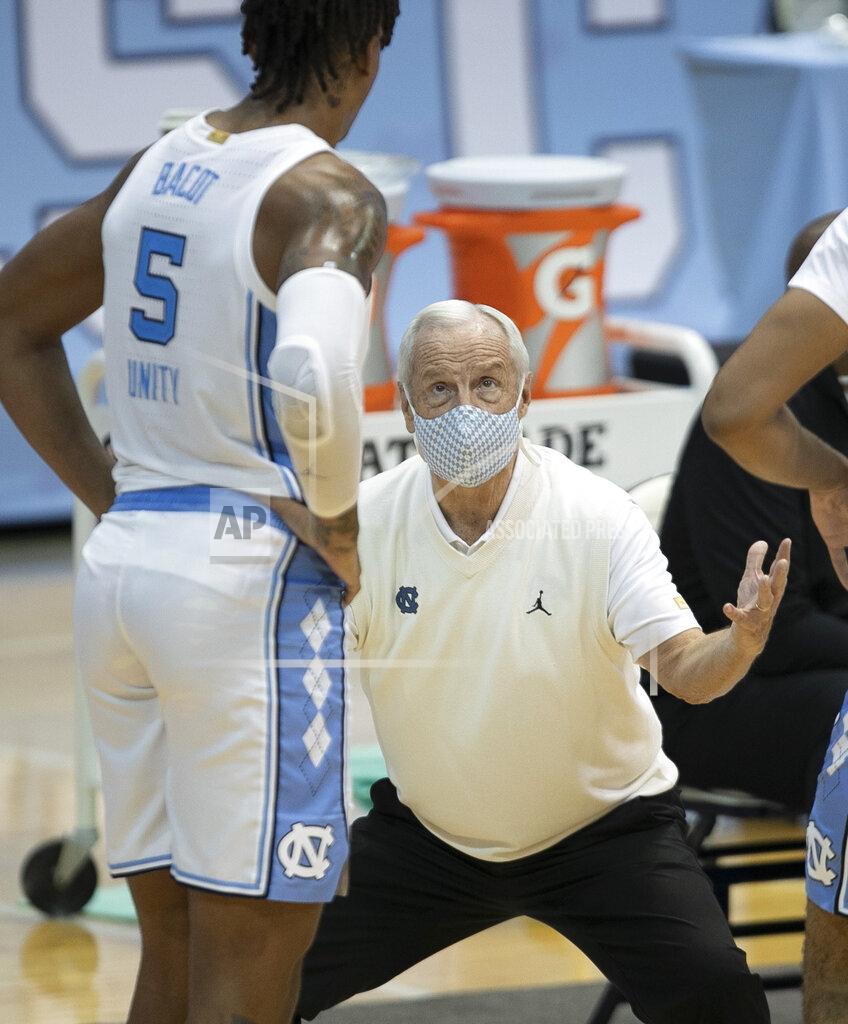 Robert Willett North Carolina coach Roy Williams has a word with Armando Bacot (5) during a time out in the second half of an NCAA college basketball game against North Carolina Central, Saturday, Dec. 12, 2020, at the Smith Center in Chapel Hill, N.C. (Robert Willett/The News & Observer via AP)