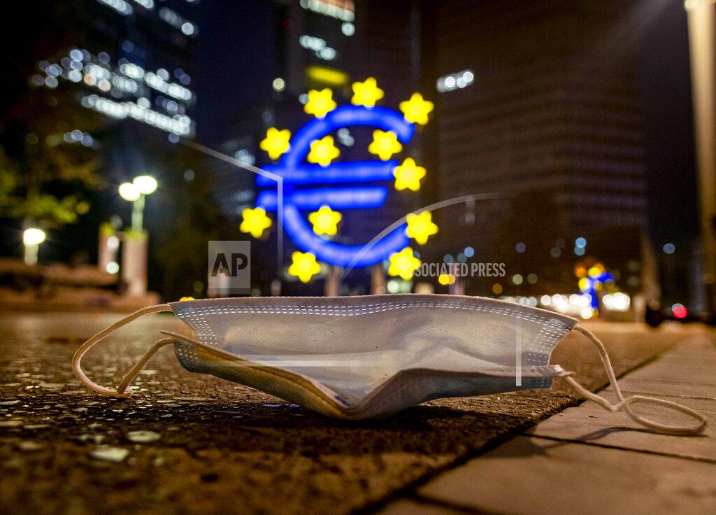 Michael Probst A face mask was left behind near the Euro sculpture in Frankfurt, Germany, early Monday, Oct. 19, 2020. (AP Photo/Michael Probst)