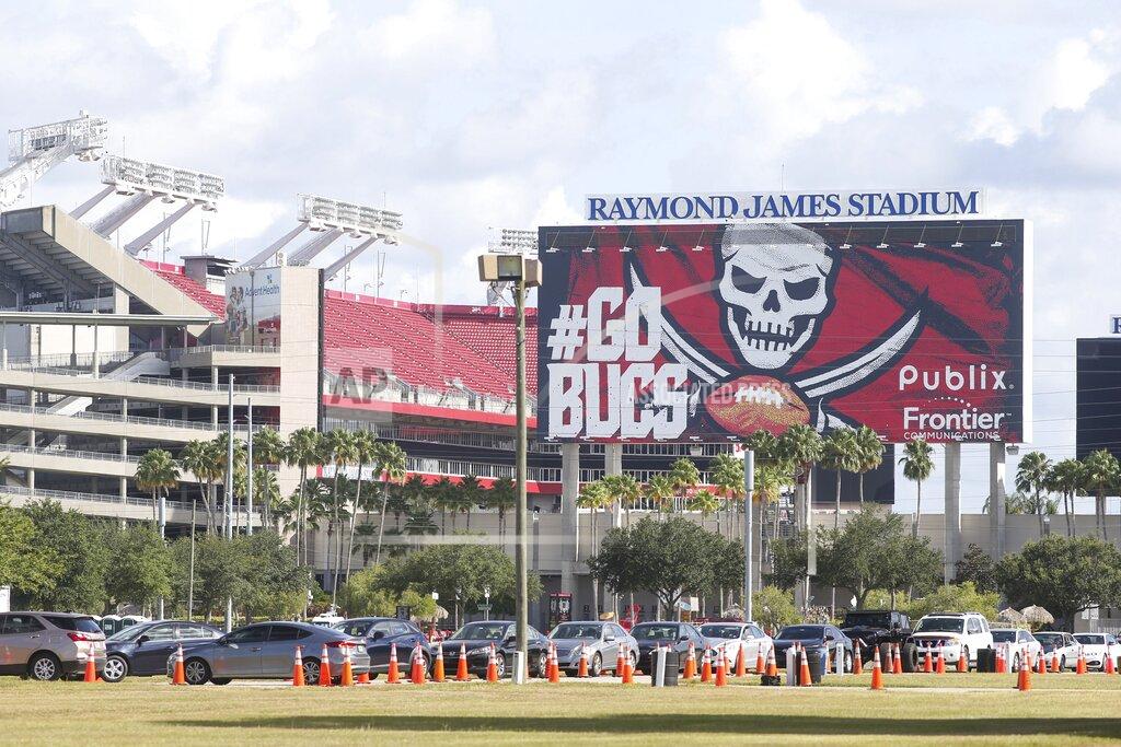 Cars line up outside Raymond James Stadium in Tampa, where the state expanded COVID-19 testing, on Tuesday, June 30, 2020. (Ivy Ceballo/Tampa Bay Times via AP)