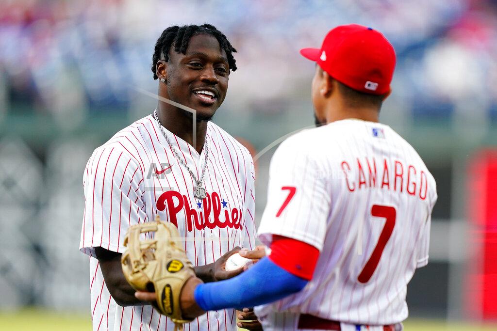 Matt Rourke Philadelphia Eagles draft pick A.J. Brown, left, meets with Philadelphia Phillies' Johan Camargo after throwing a first pitch before a baseball game between the Phillies and the Texas Rangers, Tuesday, May 3, 2022, in Philadelphia. (AP Photo/Matt Rourke)